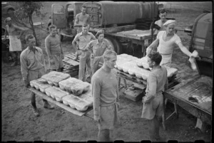 Batch of freshly baked bread being carried at 2 New Zealand Field Bakery in Italy, World War II - Photograph taken by George Kaye