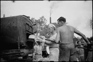 Freshly baked bread removed from outdoor ovens at 2 New Zealand Field Bakery in Italy, World War II - Photograph taken by George Kaye