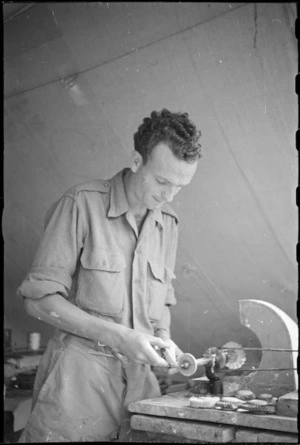 R H Fenton adjusting denture on dental lathe at New Zealand Mobile Dental Unit Headquarters in Italy, World War II - Photograph taken by George Kaye