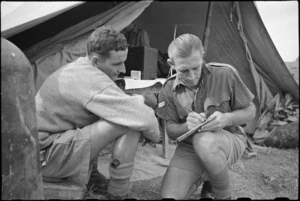 A J Reaton gives details to orderly W Courtenay before treatment at New Zealand Mobile Dental Unit in Italy, World War II - Photograph taken by George Kaye