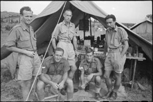Group of mechanics and orderlies outside operations tent of New Zealand Mobile Dental Unit HQ in Italy, World War II - Photograph taken by George Kaye