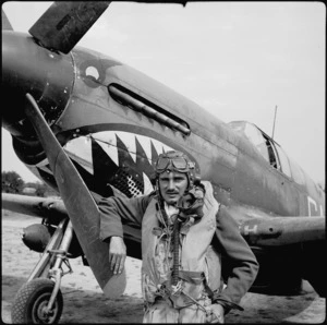 Flying Officer R H Newton beside aircraft on airfield in Italy, World War II - Photograph taken by Cedric Mentiplay