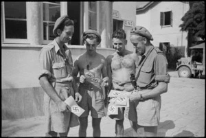 Members of a New Zealand regimental aid post with swastika leaflets in Riccione, Italy, World War II - Photograph taken by George Kaye