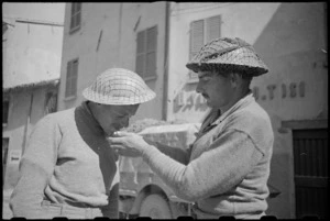R Gordon and A E Brinsden, of the 22 NZ Battalion, light up in Rimini, Italy, World War II - Photograph taken by George Kaye