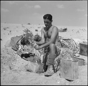 New Zealand officer doing his washing on the Alamein front, Egypt, in World War II - Photograph taken by H Paton