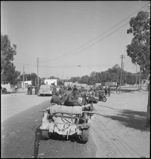 Members of Maori Battalion and transport outside the Benito Gate at Tripoli, Libya, in World War II - Photograph taken by H Paton