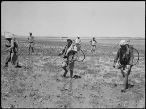 Locals carrying spraying equipment in anti malaria campaign in Syria, World War II - Photograph taken by H Paton