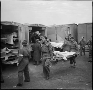 English orderlies carrying wounded soldiers to the hospital ship Maunganui at Port Tewfik, Egypt, in World War II - Photograph taken by M D Elias