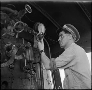 G Gregory, New Zealand Railway Operating Company, in an engine cab, Western Desert, World War II