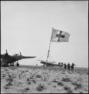 Stretcher bearers transferring wounded to air ambulance during World War II, Tunisia - Photograph taken by H Paton