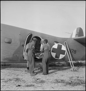 Wounded placed into air ambulance during World War II, Tunisia - Photograph taken by H Paton