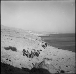 Stretcher bearers bring wounded to safety zone near Sollum, Egypt, during World War II