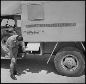 Driver of donated World War II ambulances examines name of donor on ambulance at Maadi, Egypt