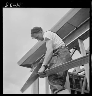Carpenter working on the construction of a state house in Naenae, Lower Hutt, Wellington