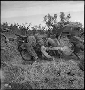 Gunners of NZ Artillery struggling to move gun into new position on the Sangro River Front, Italy, World War II - Photograph taken by George Kaye