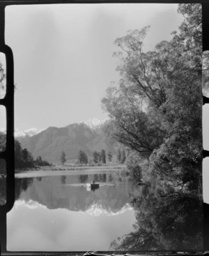 Lake Matheson, includes unidentifed man in boat and Mount Aoraki/Cook in background, West Coast Region