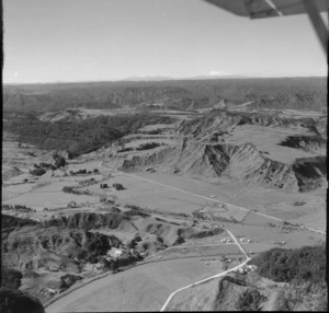 Awakino Valley, Waikato District, including houses, hills and Mount Egmont in the distance