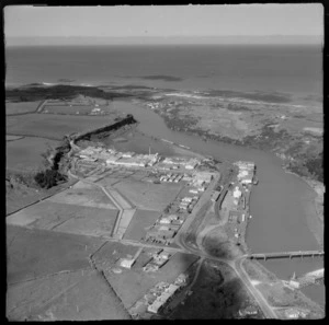 Patea Freezing Works and River Estuary with railway yards and wharf area, with Patea Road Bridges (State Highway 3) in foreground, South Taranaki Region