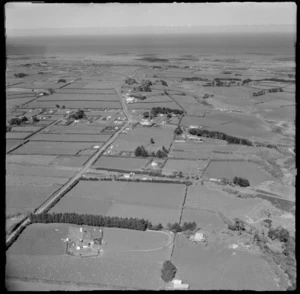 View to the coastal settlement of Kakaramea surrounded by farmland with Kakaramea Road in foreground, Patea District, South Taranaki Region