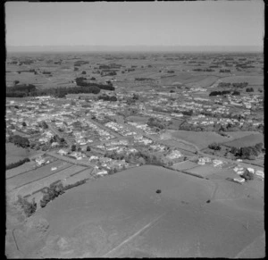 View over the town of Eltham with Mountain Road into High Street (State Highway 3) through town to farmland beyond, South Taranaki Region