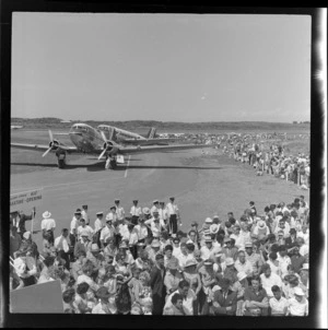 Crowd, brass band members, and two DC3 aeroplanes at Whakatane Airport opening