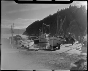 Three boats docked at Picton harbour, Marlborough District, including unidentified men and a truck