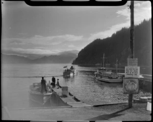 Picton harbour, Marlborough District, including docked boats and one boat departing