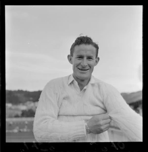 Unidentified cricketer from the Wellington cricket squad putting on his jersey during practice at the Basin Reserve, Wellington