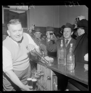 Mr E O'Grady, retiring licencee of the Thistle Inn, pouring pints of beers for customers, Mulgrave Street, Wellington