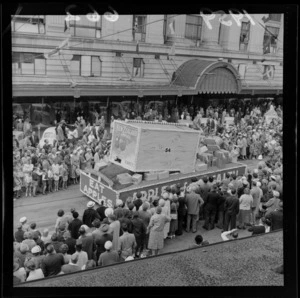 Festival of Wellington parade, showing New Zealand Apple and Pear Marketing Board parade float, and spectators, outside the DIC building, Lambton Quay, Wellington