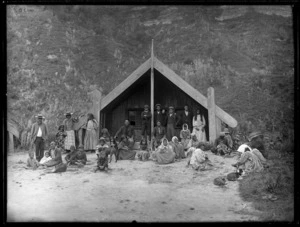 Maori group and meeting house - Photograph taken by William Henry Thomas Partington