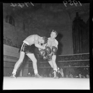 Two unidentified boxers fighting in front of a crowd at the Town Hall, Wellington
