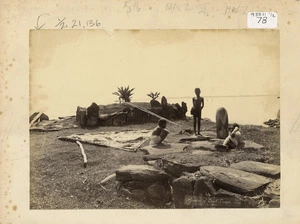 "Remains of devil temple". Fijians with canoe sail beside building remains