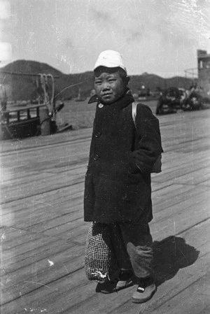 Korean child standing on wharf, Senzaki, Japan