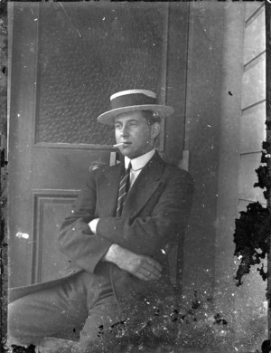 Young man seated in doorway - taken by an unknown photographer