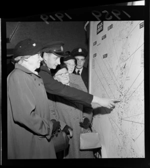 Unidentified group being shown a map of traffic accident black spots in Wellington city by a traffic officer, at a road safety film showing, Kings Theatre, Wellington