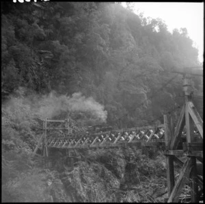 Diesel locomotive hauling coal on a bridge above the Charming Creek gorge, Buller district