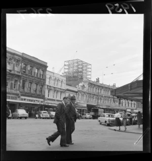 Lambton Quay, Wellington, showing unidentified pedestrians and business premises including Hill Brothers delicatessen, Electrolux Limited, Gresham Hotel, and Shell building under construction