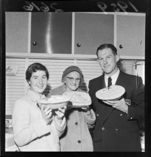 Placegetters in apple pie baking contest, holding their winning pies