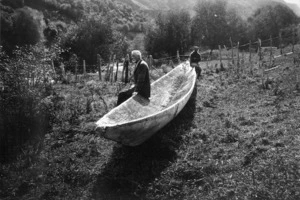 Photograph of Elsdon Best and another man sitting on a canoe