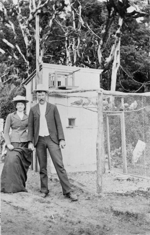 Mr Phipps and unidentified woman by the pigeon aviary, alongside the Mountain House, Mount Taranaki