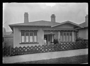 Albert Percy Godber, his wife Laura, and their daughter Phyllis outside their home in Dunedin.
