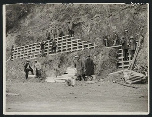Creator unknown : Photograph of relief workers building a retaining wall during road construction works