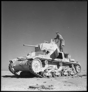 New Zealand soldier examining an Italian tank, Egypt, during World War 2
