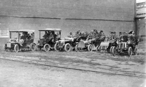Row of motorcars with passengers