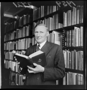 Portrait of Mr TP Shand, in a library