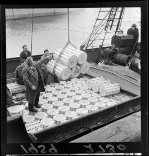 Cheese being unloaded from a ship at Wellington wharves, including unidentified shipworkers