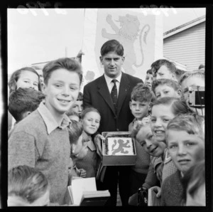 Malcolm Thomas, a member of the British Lions rugby team, surrounded by unidentified schoolchildren at Korokoro School, Wellington