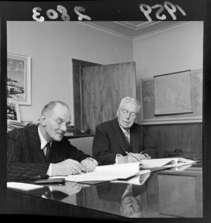 Walter Nash and the retiring High Commissioner of the United Kingdom to New Zealand, Sir George Mallaby, signing documents in an office
