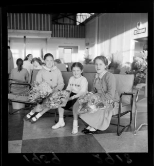 [Svetlana? Rodvonov?] and other unidentified girls, with flower bouquets, waiting for Russian Ballet stars to arrive, probably Wellington region